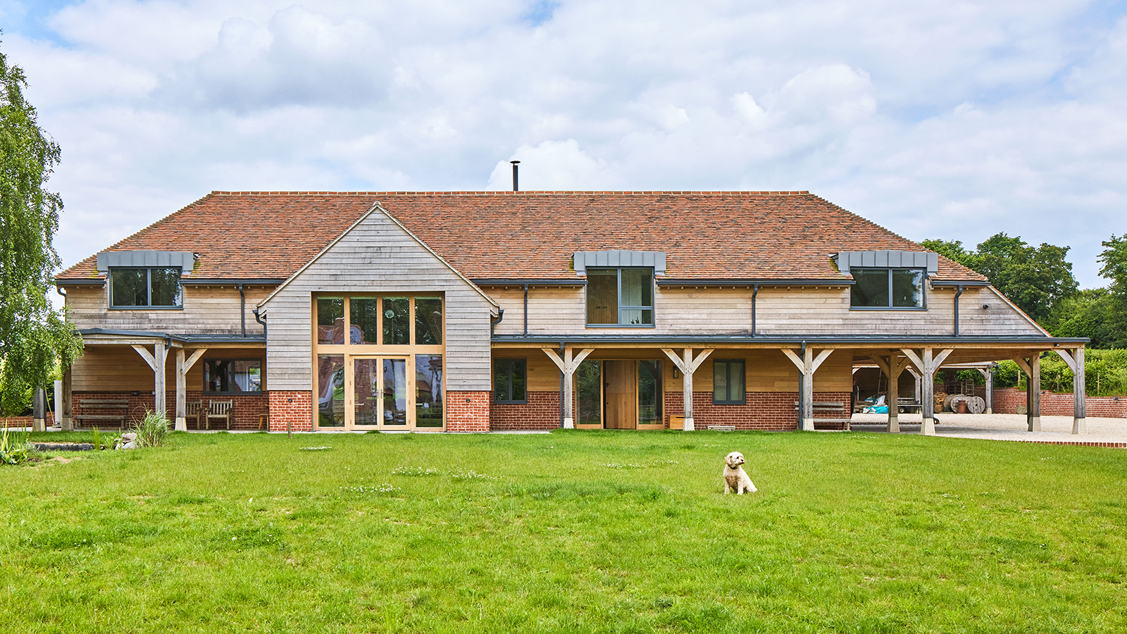 The exterior of a large self-build home with a lawn 