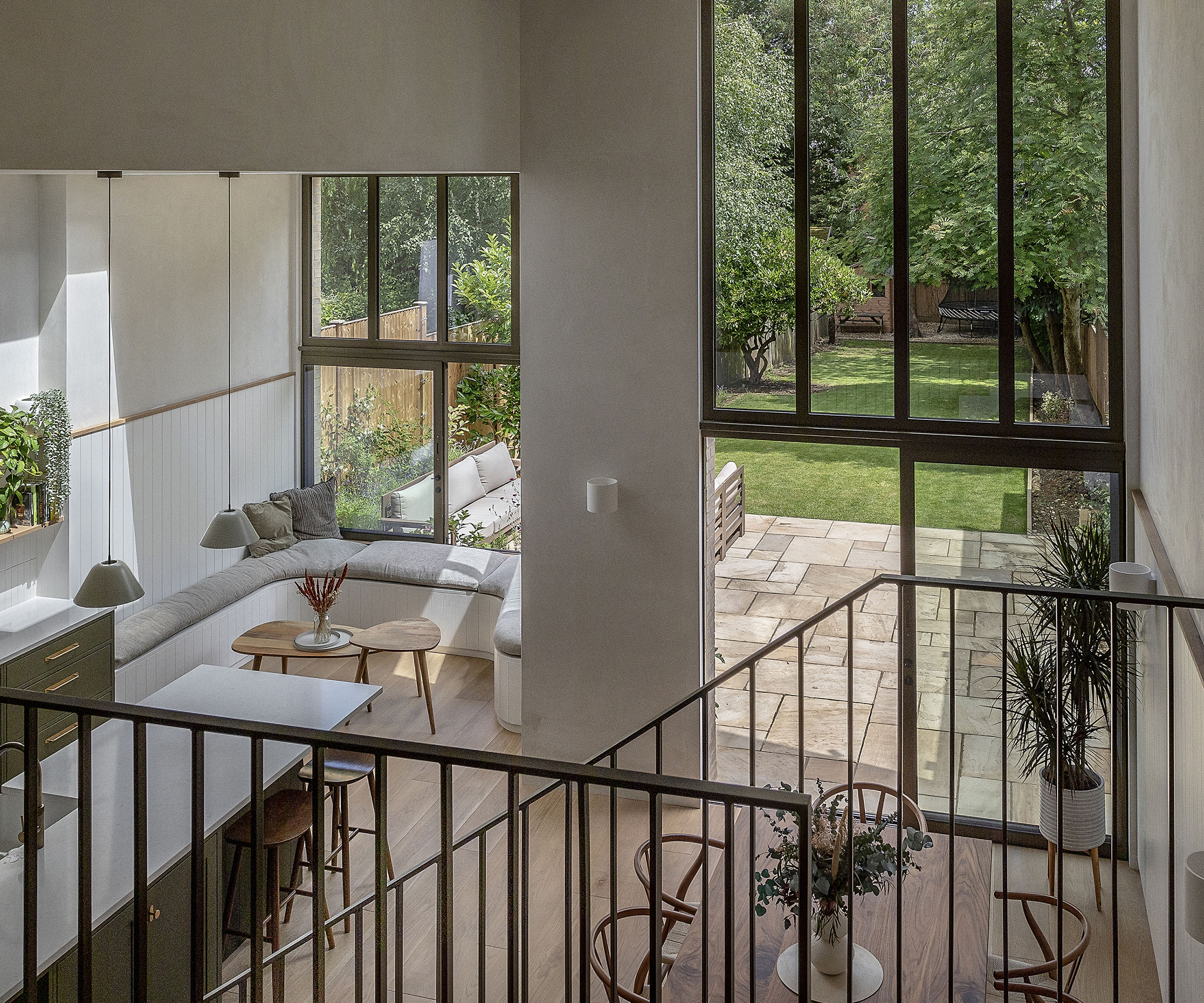 Double height extension with beautiful glazing and matching railings with built in window seating
